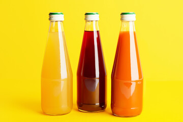 Bottles of juices on color background