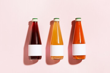 Bottles of juices on color background