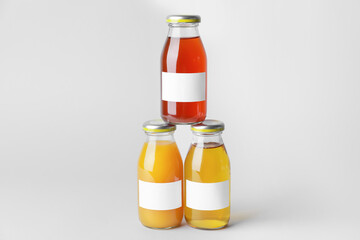 Bottles of juices on light background