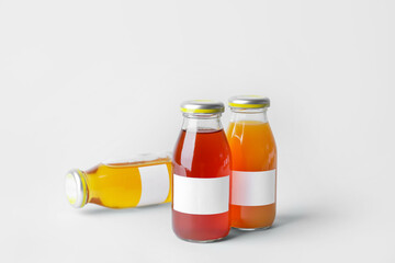 Bottles of juices on light background