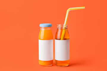 Bottles of juices on color background
