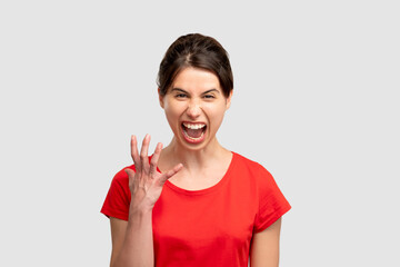 Furious woman portrait. Feeling rage. Mad screaming lady isolated on neutral copy space....