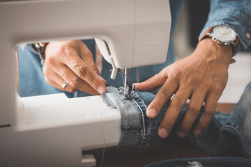 tailor working with jeans.