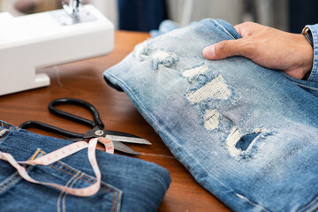 tailor working with jeans.