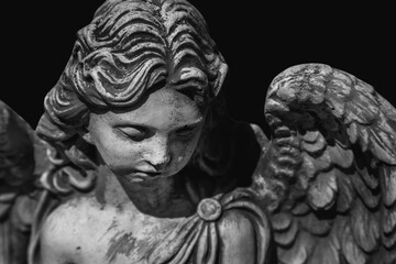 Death. Portrait of sad angel as symbol of pain, fear and end of life. Gragment of an ancient stone statue.