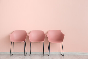 Modern chairs near color wall