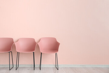 Modern chairs near color wall