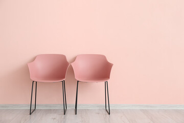 Modern chairs near color wall