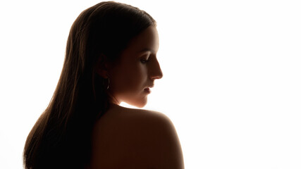 Silhouette profile portrait. Spa procedure. Naked woman closing eyes staying backside. Isolated on white copy space. Skin and body care. Natural beauty. Plastic surgery