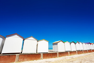 Naklejka premium Many wooden cabins and kiosks on Etretat, France over sea with blue sky