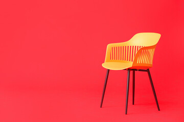 Modern chair on color background