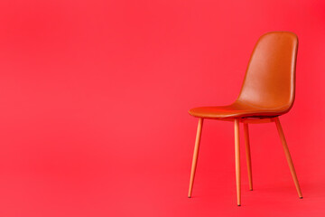Modern chair on color background
