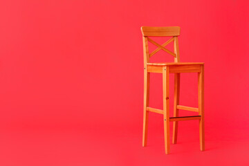 Wooden chair on color background