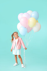 Little girl with balloons on color background