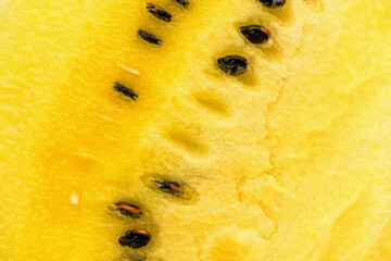 Closeup of fresh yellow watermelon slices on white plate