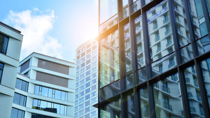 Fototapeta premium Office building, details of blue glass wall and sun reflections.