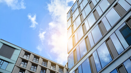 Fototapeta premium Office building, details of blue glass wall and sun reflections.