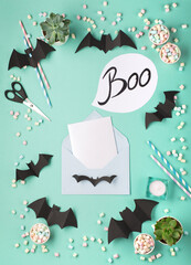Halloween decorations on green mint paper background. Halloween holiday concept. Flat lay, top view.
