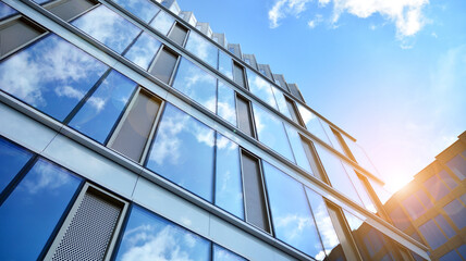 Obraz premium Office building, details of blue glass wall and sun reflections.
