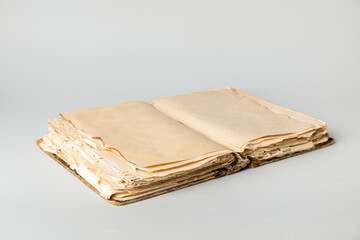 Open old book on light background