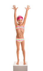Little girl in swimsuit on white background