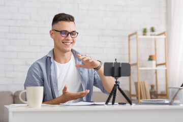Work and study online during self-isolation. Man gestures and looks at smartphone