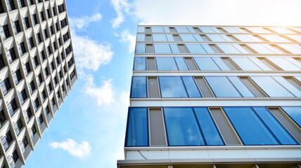 Office building, blue glass wall reflection detail. Modern office building and clear sky...