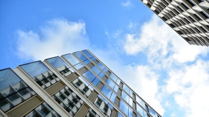 Office building, details of blue glass wall and sun reflections.