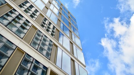 Office building, blue glass wall reflection detail. Modern office building and clear sky background. 