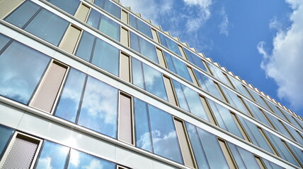 Fototapeta na wymiar Office building, blue glass wall reflection detail. Modern office building and clear sky background. 