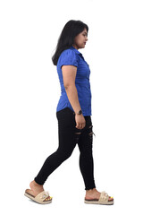 side view of a full portrait of a latin woman walking on white background,