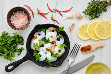 Fototapeta na wymiar Top view of pan with fresh raw prawn with spice and herbs