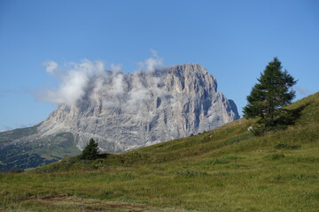 Langkofel mountain, Italian Dolomites, with screes and meadows in the foreground.