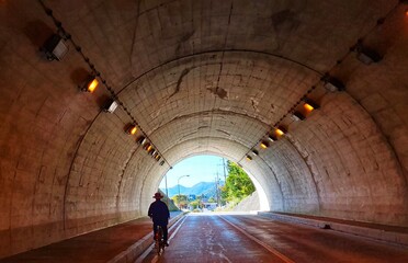 Man riding a bike in a tunnel in Japan