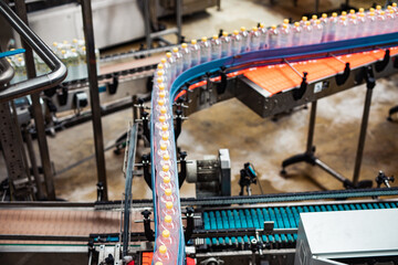 Bottling factory - Juice bottling line for processing and bottling lemon juice into bottles. Selective focus.