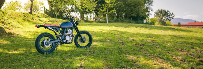 Beautiful vintage custom motorcycle parked on the field
