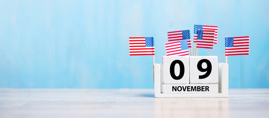 9 November of white Calendar with United States of America flag on wood background. Veterans day...