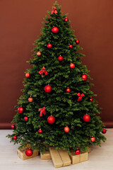 Interior Christmas tree with gifts for new year decor winter red background