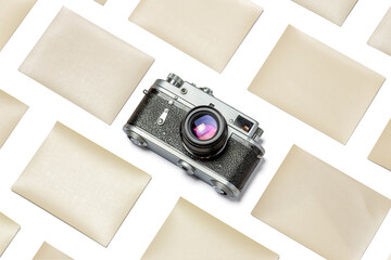 Mockup composition of old rangefinder film camera and photographic paper on white background.