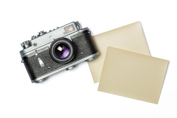Mockup composition of old rangefinder film camera and photographic paper on white background.