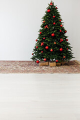 The interior of the white room is a green Christmas tree with red gifts for the new year decor winter holiday