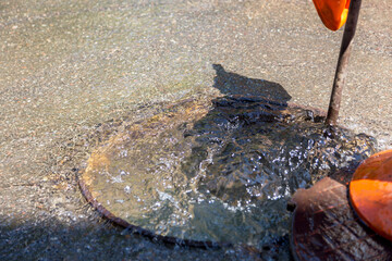 Accident of water supply, sewage. Water fountain pours out from under the road sewer. Breakthrough...