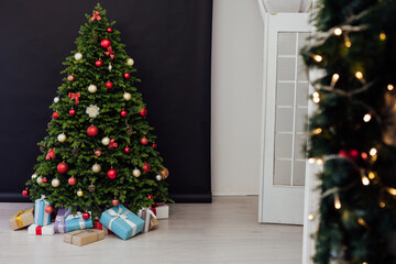 The interior of the room is a green Christmas tree with red gifts for the new year decor of the winter holiday home