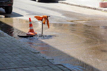 Accident of water supply, sewage. Water fountain pours out from under the road sewer. Breakthrough...