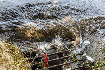 Accident of water supply, sewage. Water drains out of sewer hatch and flows down road. Emergency...