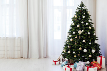 Christmas interior of the white room green Christmas tree with red gifts for the new year decor winter holiday