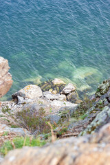 Top view of beautiful blue water from stone cliff