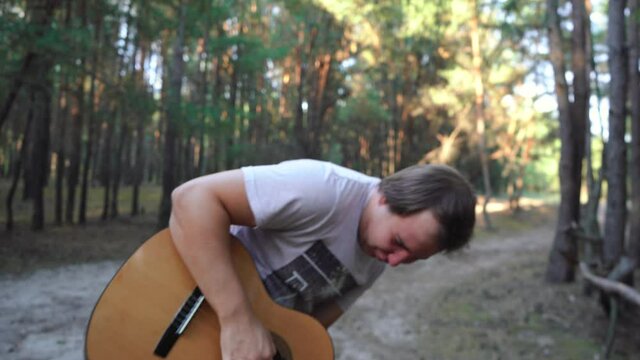 man playing the guitar wildly and writhes