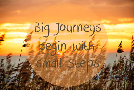 English Quote Big Journeys Begin With . Beach Grass At Sunrise Or Sunset In Background