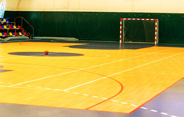 Gym for playing futsal, mini-football. Folded wooden parquet on the field of hall for...